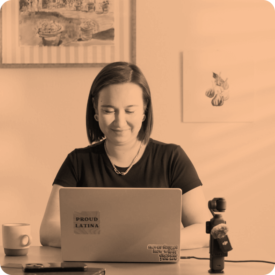 Gina Knox smiles while working on her laptop